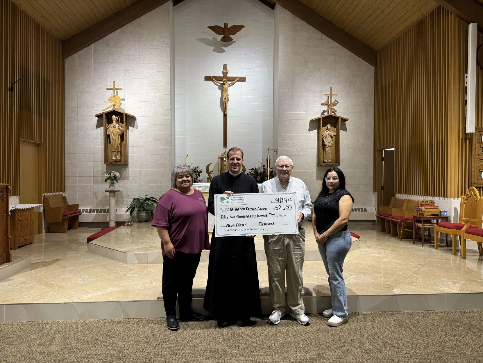 Community Foundation Noble County presents Scholarships and Grants in Noble County, including Kendallville, Ligonier, Albion, Avilla, Rome City, Cromwell, and Wolcottville. Four people hold a large check.